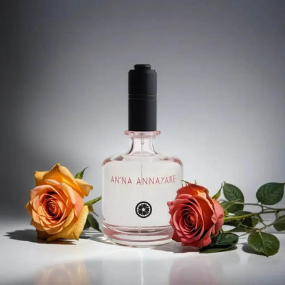 Glasflakon Eau de Parfum mit schwarzen Deckel, umgeben von zwei Rosen, luxuriöses Damenparfum