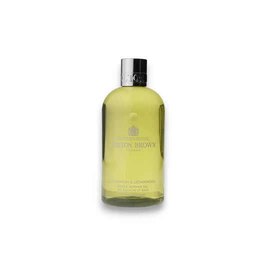 Gelbes Duschgel in transparenter Flasche mit silbernem Verschluss, Produktfoto auf weißem Hintergrund.