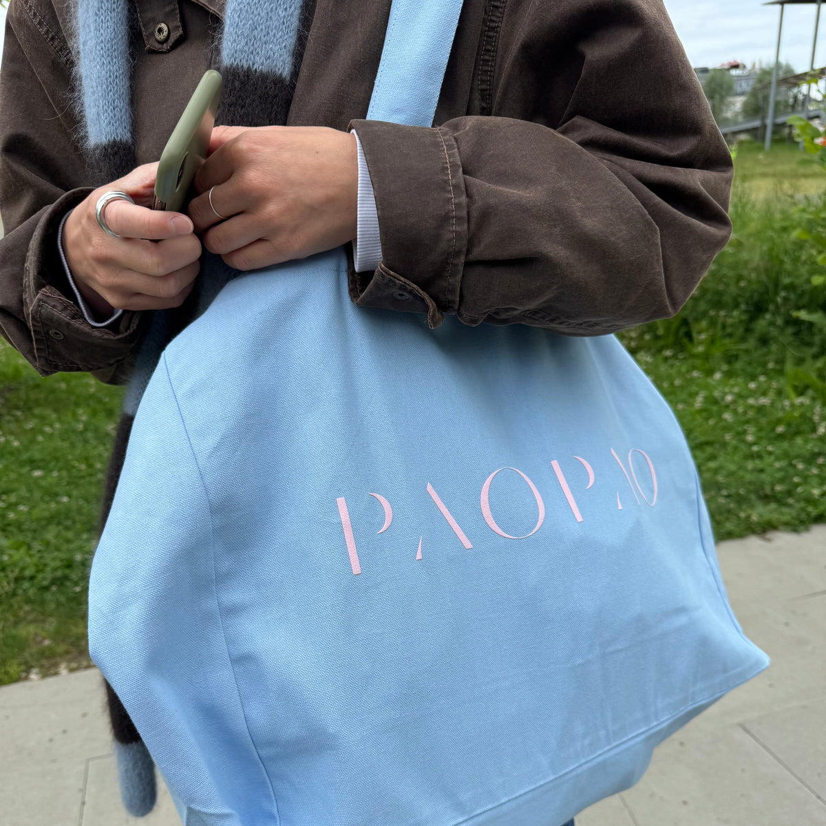 Hellblaue Tote Bag von paopao essentials mit rosa Schriftzug.
