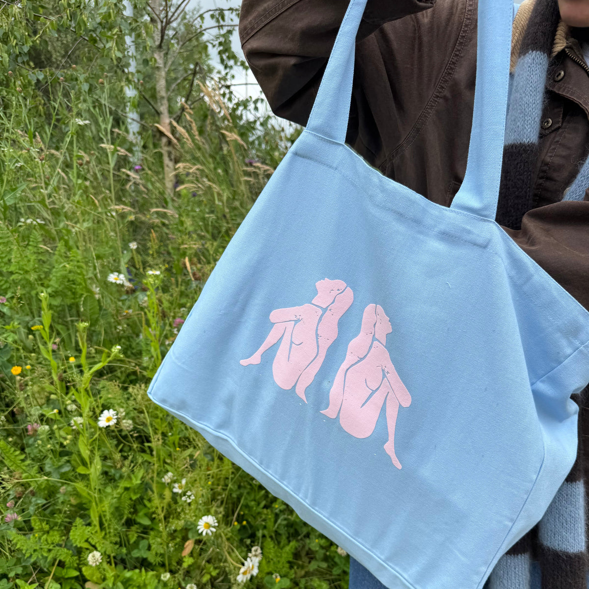 Hellblaue Tote Bag von paopao essentials mit rosa Motiv 'sacred feminine'.