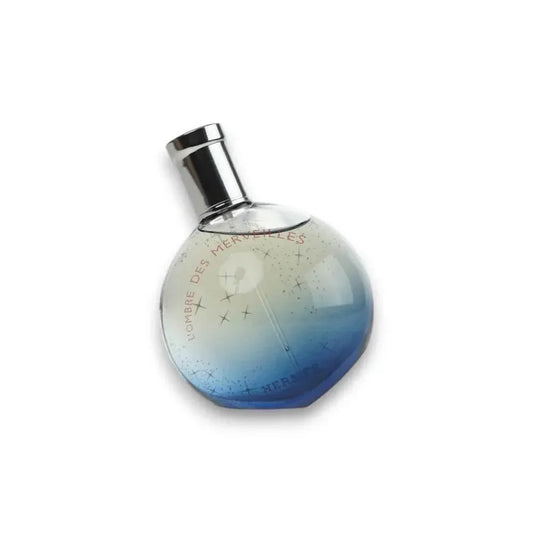 Runder Parfumflakon mit silbernem Verschluss und blauem Farbverlauf, L'Ombre des Merveilles.
