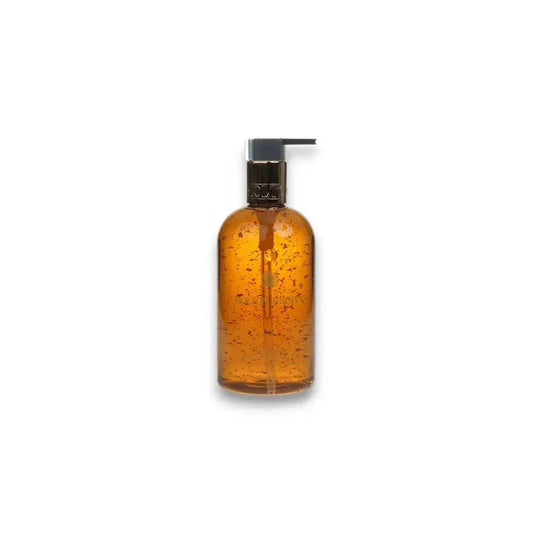 Luxuriöse Handseife mit goldenen Partikeln in eleganter Pumpflasche, transparentes Design