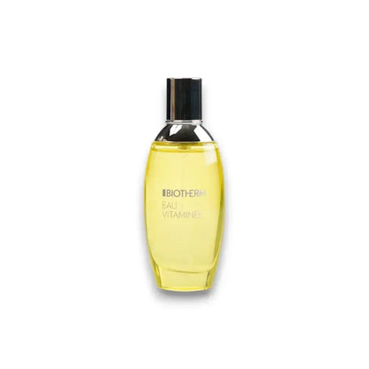 Gelbes Eau de Toilette Biotherm Eau Vitaminée Flakon mit silbernem Deckel auf weißem Hintergrund
