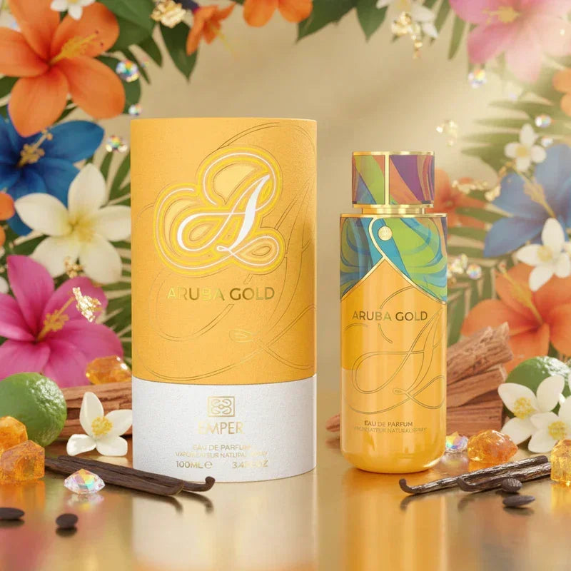 Emper Aruba Gold Eau de Parfum Flakon und goldene Verpackung vor bunten Blumen.