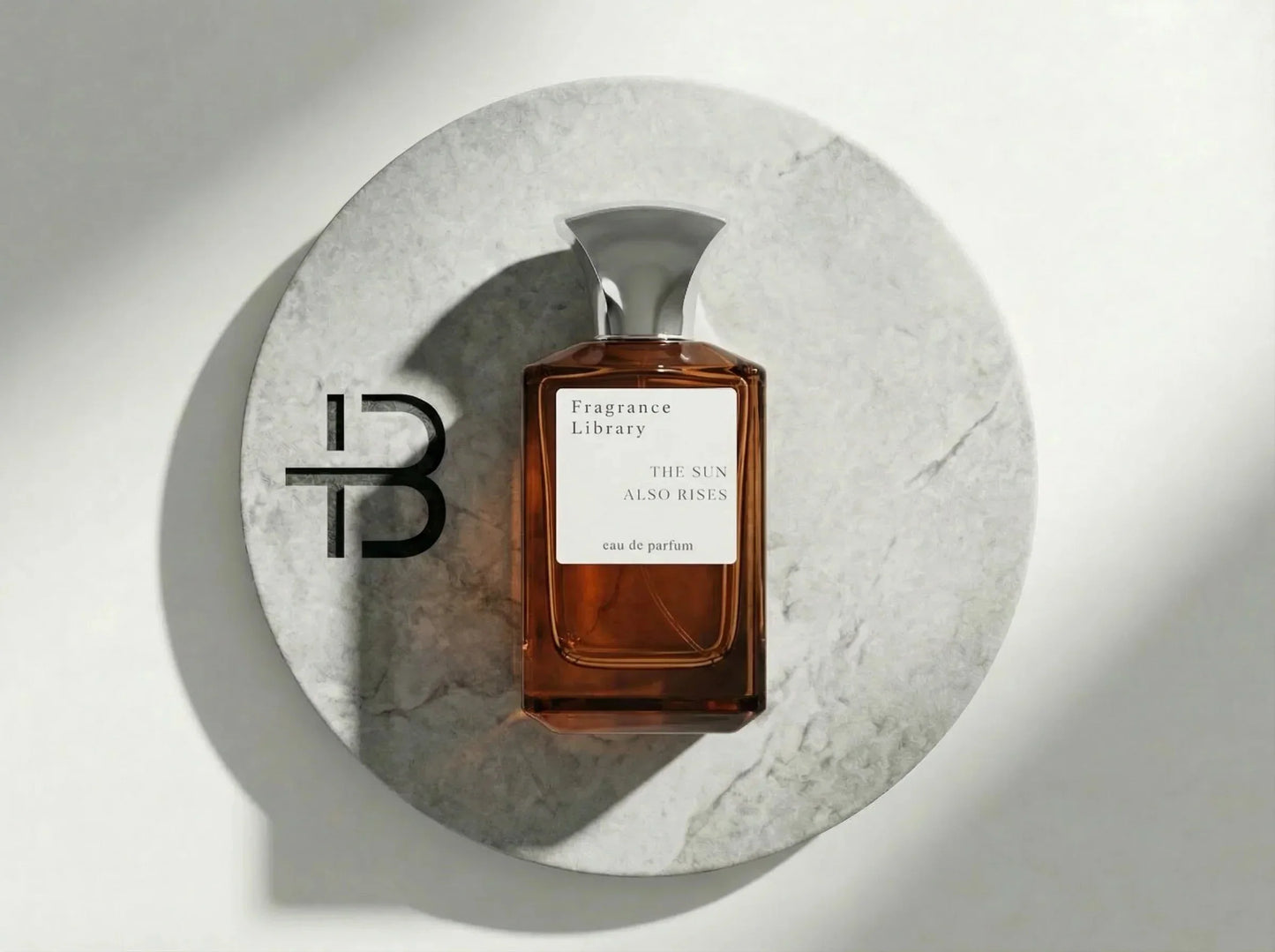 Luxusparfum Flakon The Sun Also Rises auf rundem Marmor, eleganter Duft, Eau de Parfum