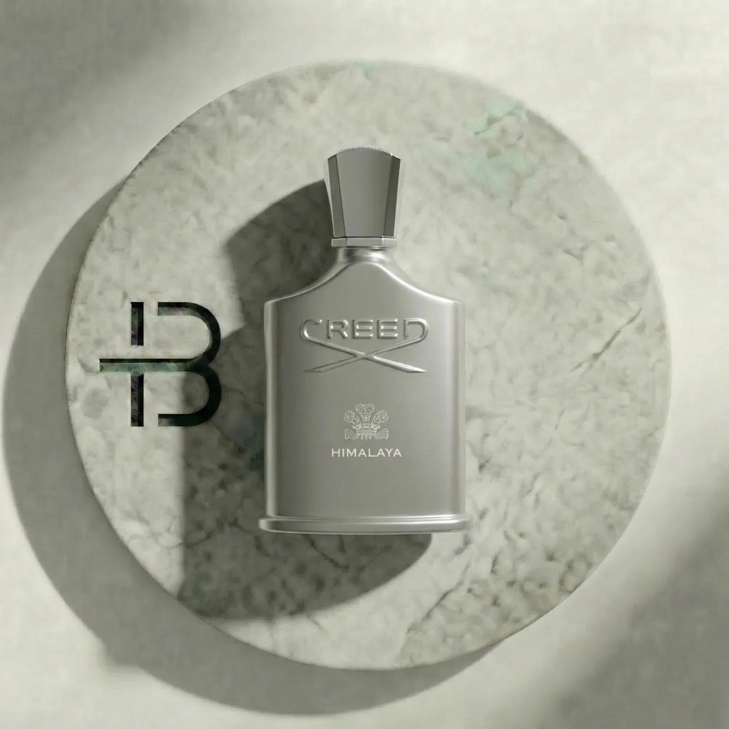 Silbernes Creed Himalaya Parfumflakon für Herren auf rundem Marmortablett, edles Luxusparfum